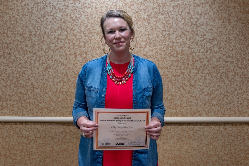 Woman holding certificate. 